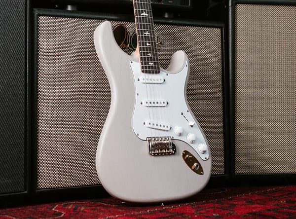 PRS Silversky Dead Spec body leaning against an amp.