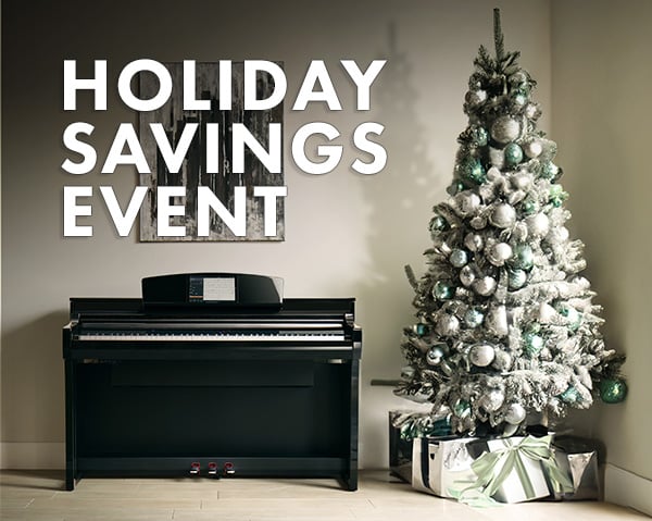 Image of piano next to tree with text reading: Holiday Savings Event