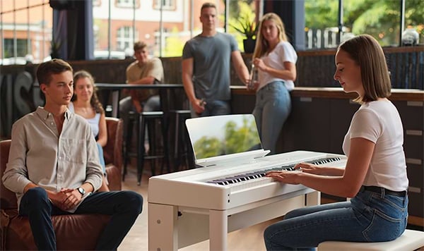 Woman performing with Kawai ES520 in crowded coffee shop